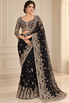 AI-generated model wearing black beadwork net saree
