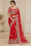 AI-generated model wearing red beadwork net saree